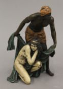 A cold painted bronze model of an Arab and nude. 14 cm high.