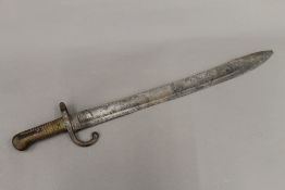 A 19th century serrated bayonet. 60 cm long.