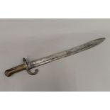 A 19th century serrated bayonet. 60 cm long.