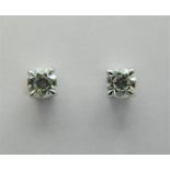 A pair of 18 ct white gold, diamond stud earrings. Total diamond weight approximately 0.