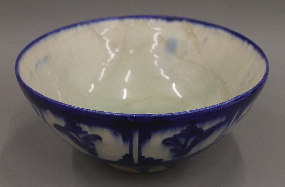 An antique Persian blue and white pottery bowl. 22 cm diameter.