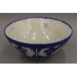 An antique Persian blue and white pottery bowl. 22 cm diameter.