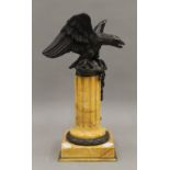 A 19th century bronze model of an eagle, on a sienna marble column. 31 cm high.
