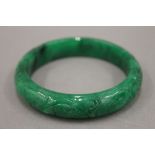 An apple green jade bangle. 7 cm diameter.