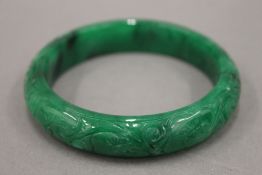 An apple green jade bangle. 7 cm diameter.