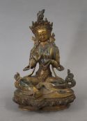 A Chinese gilt bronze model of Buddha set with cabochons. 21 cm high.