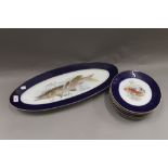 A set of porcelain plates decorated with fish. The largest 60 cm wide.