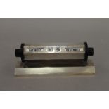 A silver desk calendar. 13 cm wide. 7.8 troy ounces total weight.