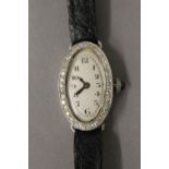 A diamond set ladies platinum cocktail watch. 1.8 cm wide.