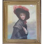 An oil on canvas, portrait of a young lady in a feathered hat, framed and glazed. 48 x 58 cm.