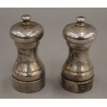 A pair of silver salt and pepper grinders. 10 cm high. 8.5 troy ounces total weight.