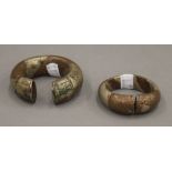 Two mixed metal money bracelets. The largest 9 cm wide.