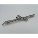 An Edwardian platinum, diamond and sapphire bow brooch with an 18 ct yellow gold hallmarked pin.