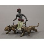 A cold painted bronze model of an Arab and tigers. 7 cm high.