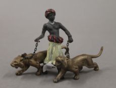 A cold painted bronze model of an Arab and tigers. 7 cm high.