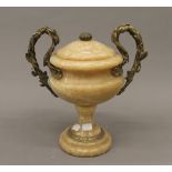 A gilt metal mounted twin handled urn. 29 cm high.