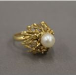 An unmarked, probably 18 ct gold, Contemporary domed pearl set ring. Ring size L. 10.