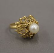 An unmarked, probably 18 ct gold, Contemporary domed pearl set ring. Ring size L. 10.