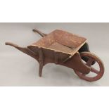 A 19th century child's wheelbarrow. 74 cm long.