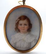 A 19th century portrait miniature on ivory of a young girl, framed. 5.5 cm wide.