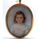 A 19th century portrait miniature on ivory of a young girl, framed. 5.5 cm wide.