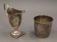 A small silver cream jug and a Continental silver beaker. The former 9.5 cm high. 89.3 grammes.