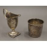 A small silver cream jug and a Continental silver beaker. The former 9.5 cm high. 89.3 grammes.