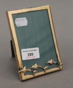 An 800 silver photograph frame decorated with dolphins. 9.5 x 13.5 cm.