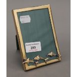 An 800 silver photograph frame decorated with dolphins. 9.5 x 13.5 cm.