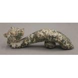 A Chinese jade dragon form belt hook. 11 cm high.