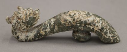 A Chinese jade dragon form belt hook. 11 cm high.