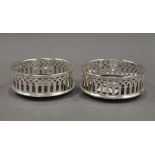 A pair of silver plated coasters. 12.5 cm diameter.