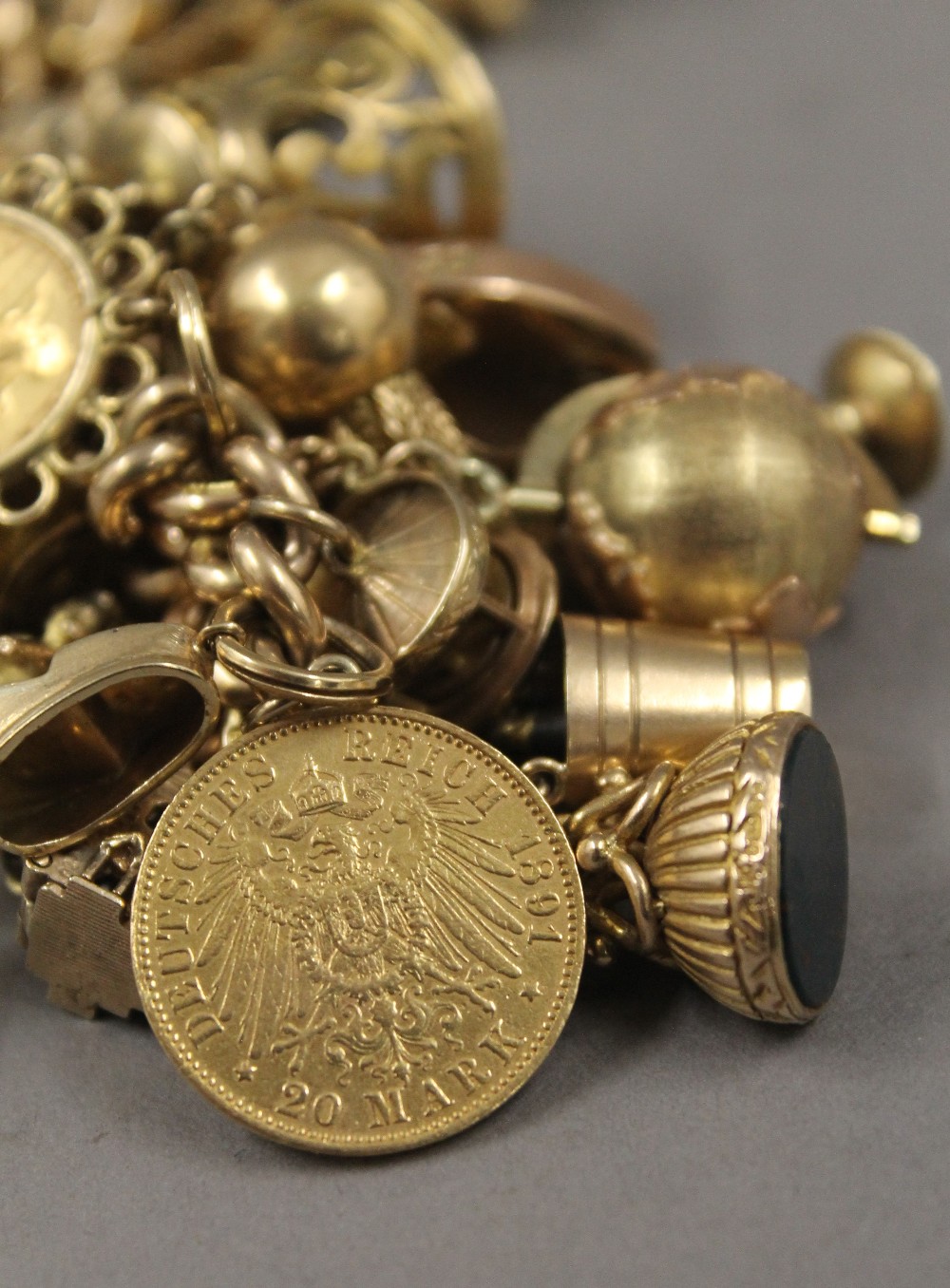 A 9 ct gold charm bracelet, set with various gold coins, including two sovereigns. 218. - Image 17 of 20