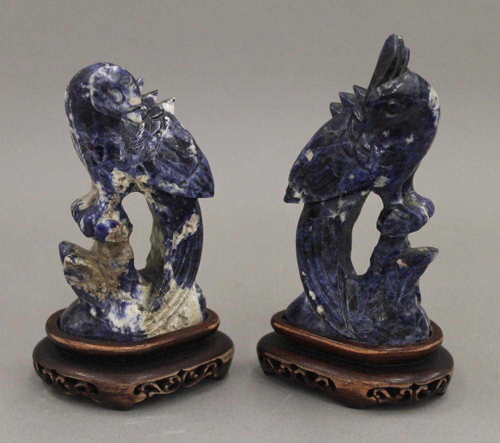 A pair of Chinese carved lapis carved birds, on stands. The largest 16 cm high overall.