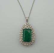 An 18 ct white gold diamond and emerald pendant on chain. The pendant 3.5 cm high. 15.