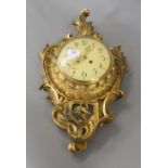 A gilt wooden Cartel clock. 45 cm high.