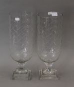 A pair of cut glass storm lamps. 40 cm high.