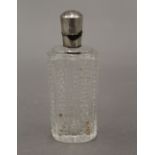 A silver topped cut glass perfume/scent bottle. 8.5 cm high.