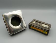 A silver matchbox case and a silver mounted pocket watch case. The former 8 cm long.