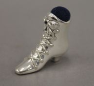 A silver pin cushion in the form of a boot. 4 cm high.