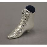 A silver pin cushion in the form of a boot. 4 cm high.