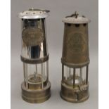 Two miners lamps. The largest 25 cm high.