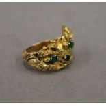 A Contemporary 18 ct gold emerald set ring. Ring size F/G. 11.8 grammes total weight.