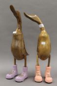 Two wooden ducks, in boots. The largest 49.5 cm high.