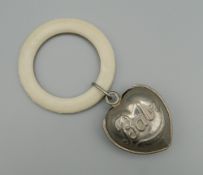 A vintage heart shaped baby rattle. 5 cm high.