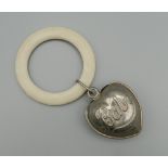 A vintage heart shaped baby rattle. 5 cm high.