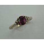 An 18 ct white gold diamond and ruby ring. Ring size K. 2.8 grammes total weight.