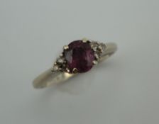 An 18 ct white gold diamond and ruby ring. Ring size K. 2.8 grammes total weight.