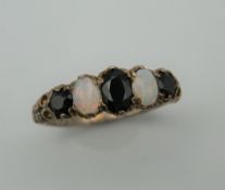 A silver opal and sapphire ring. Ring size O.