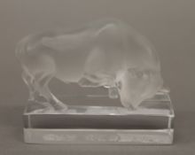 A Lalique glass model of a bull, inscribed LALIQUE FRANCE. 11 cm wide.